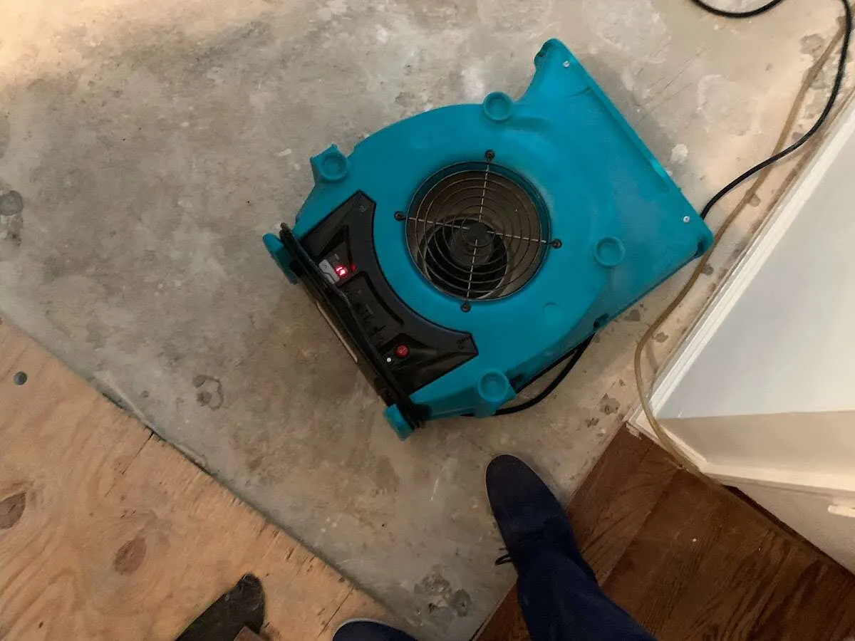Air mover drying subfloor during Leak Detection & Repair in Grant-Valkaria